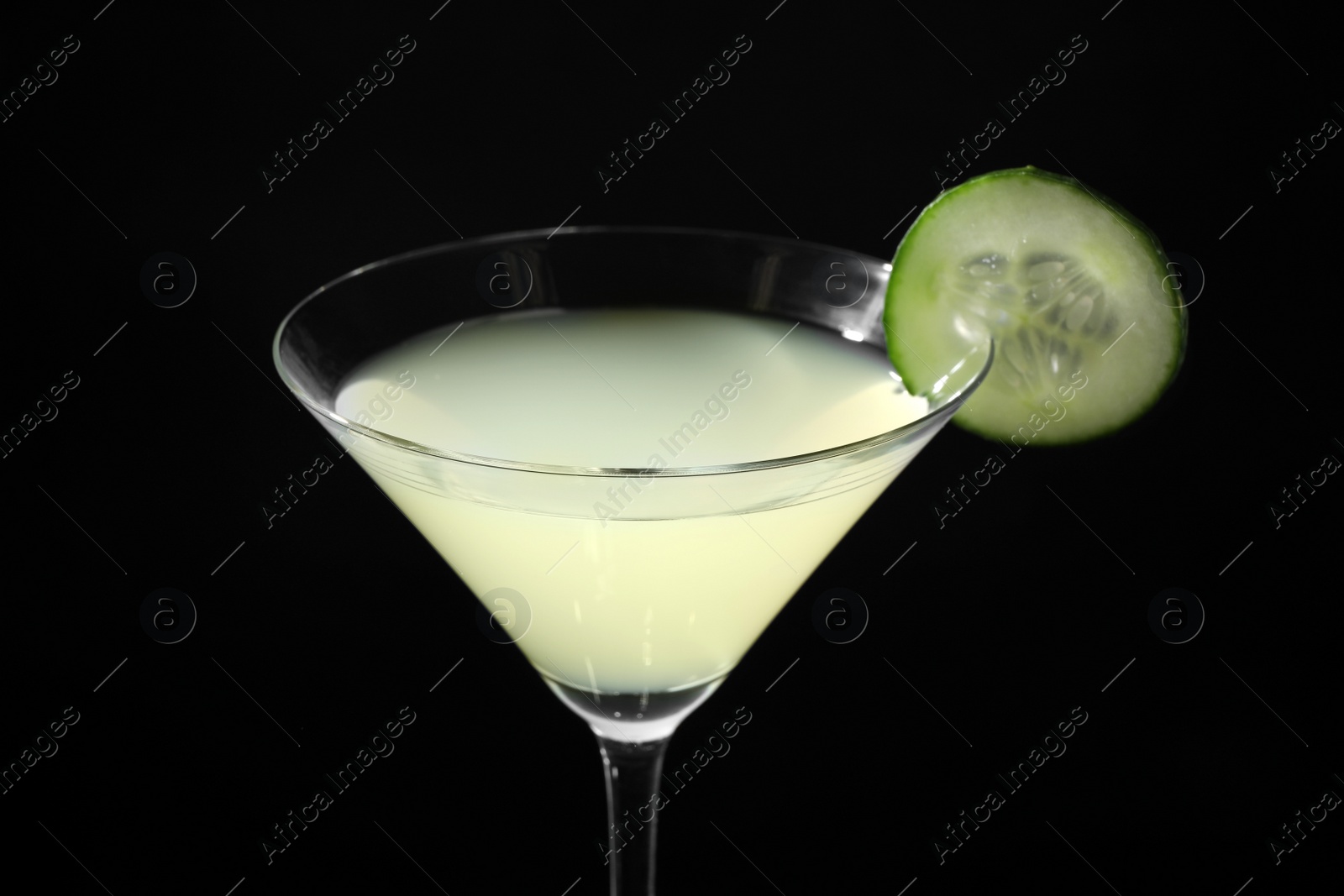 Photo of Glass of delicious cucumber martini on dark background, closeup