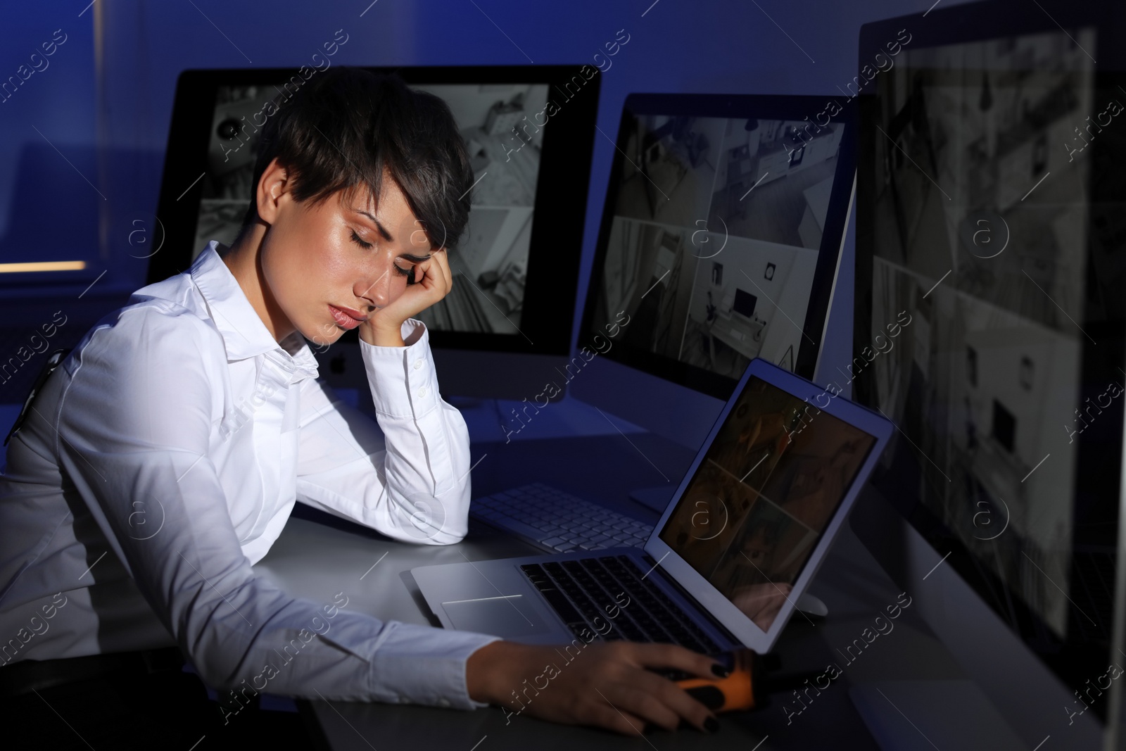 Photo of Female security guard sleeping at workplace indoors