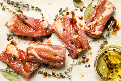 Photo of Raw marinated ribs with thyme and peppercorn, flat lay