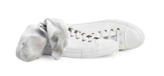 Photo of Dirty socks and sneakers on white background