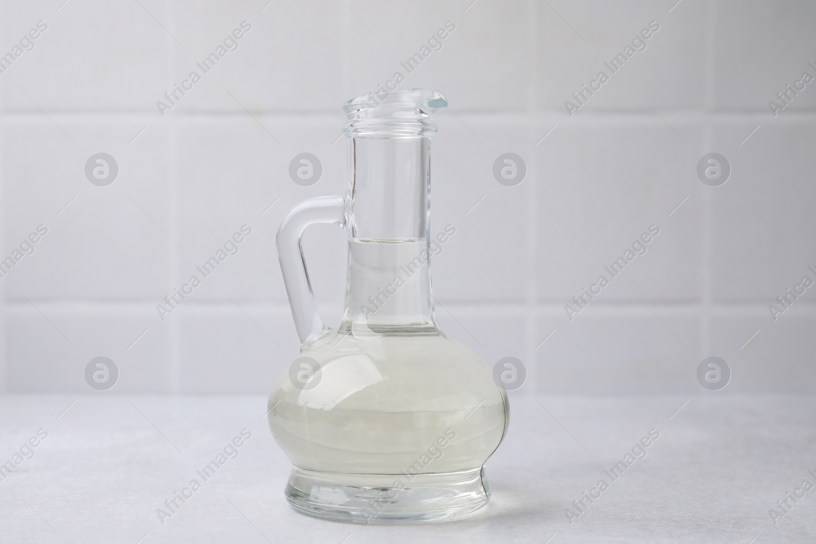 Photo of Vinegar in glass jug on light table