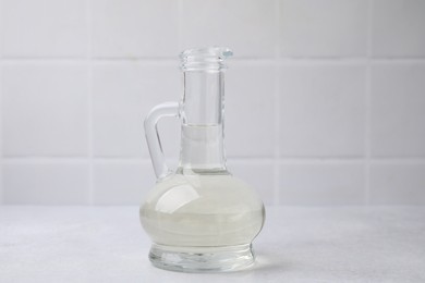 Photo of Vinegar in glass jug on light table