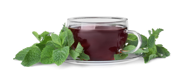 Photo of Cup with hot aromatic mint tea and fresh leaves isolated on white