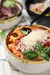 Photo of Delicious pasta with tomato sauce, basil and parmesan cheese on white table, closeup