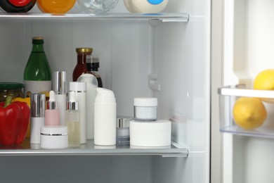 Photo of Different cosmetic products on shelf in refrigerator