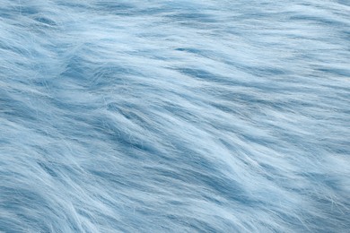 Texture of light blue faux fur as background, closeup