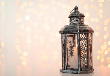 Photo of Decorative lantern and blurred lights on background, space for text. Bokeh effect