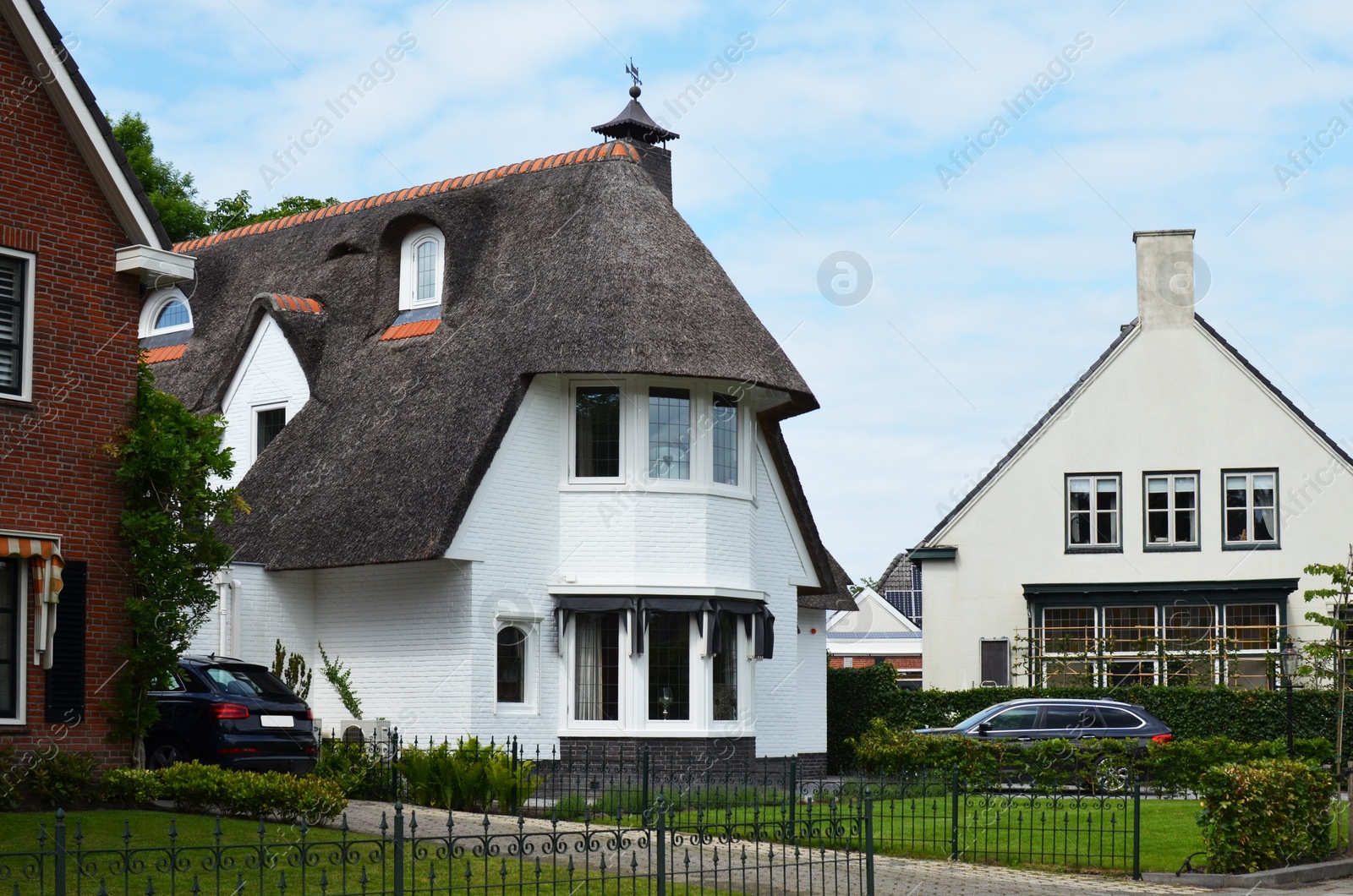 Photo of Exterior of beautiful houses surrounded by greenery