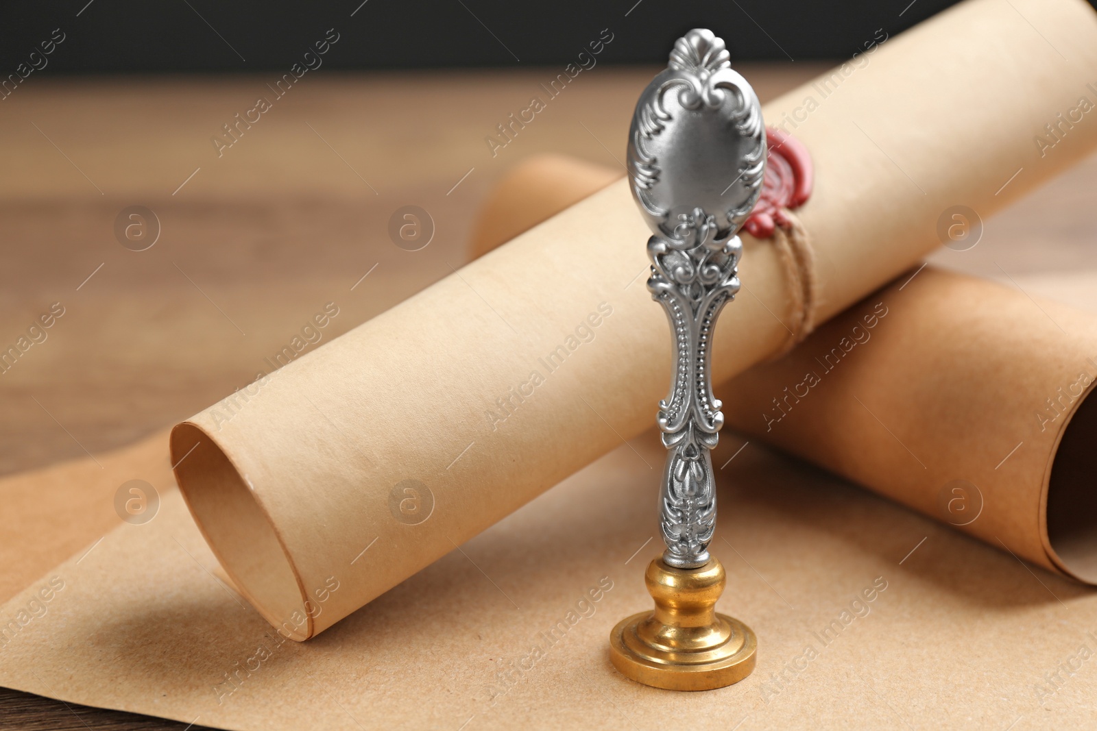 Photo of Notary's public pen and document with wax stamp on table, closeup