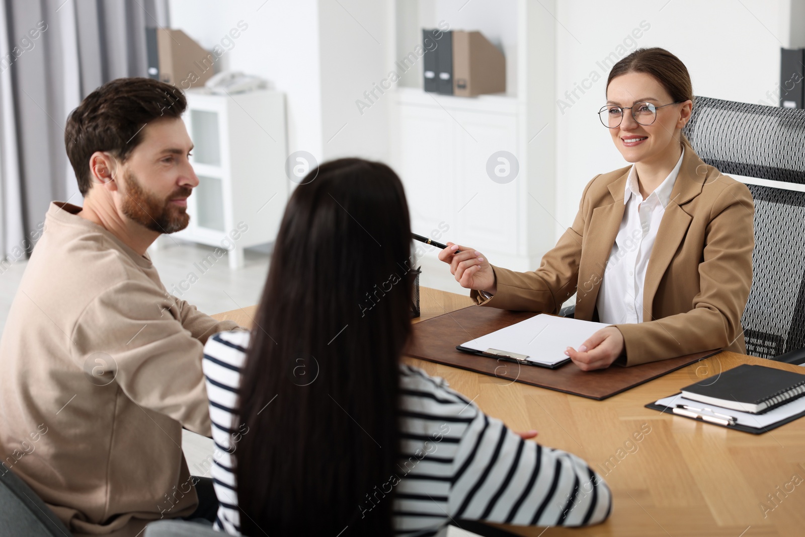 Photo of Couple having meeting with lawyer in office