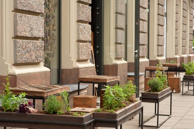 Photo of Wooden stools and tables near cafeteria outdoors