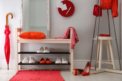 Photo of Cozy stylish hallway interior with shoe rack and mirror. Home design idea