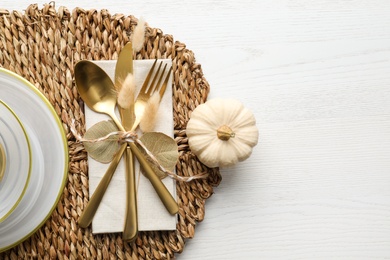 Autumn table setting and pumpkin on white wooden background, flat lay. Space for text