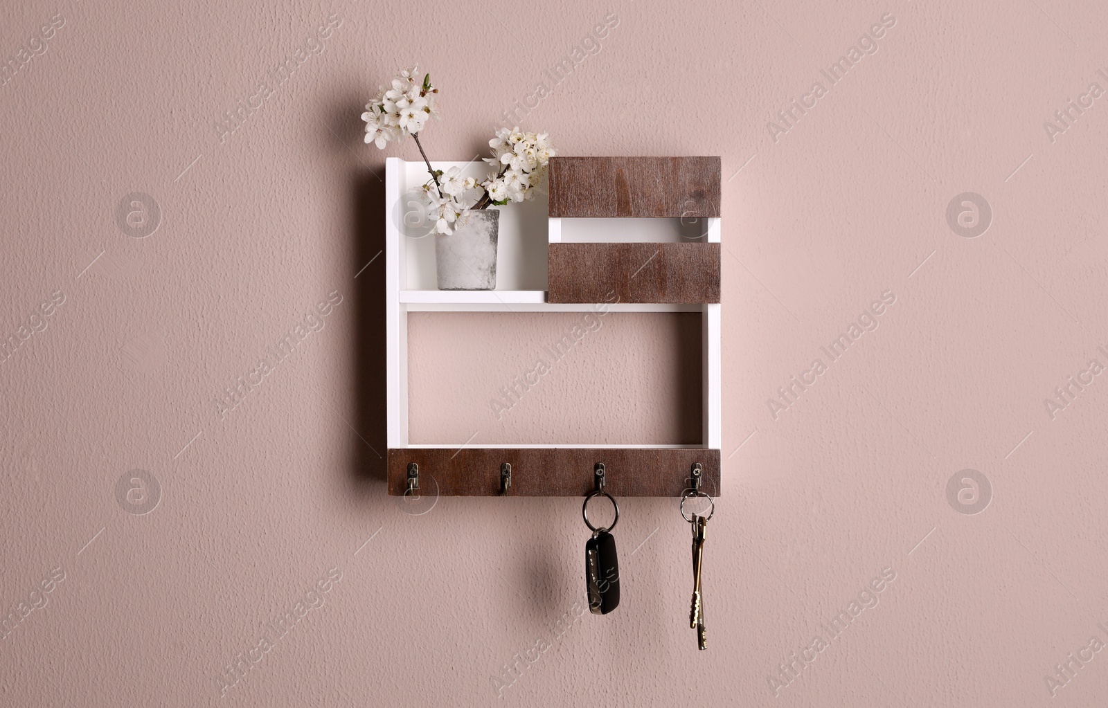 Photo of Wooden hanger for keys on color wall