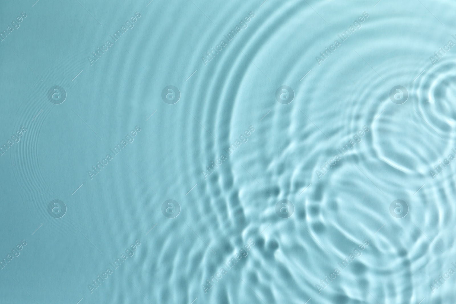 Photo of Closeup view of water with circles on turquoise background