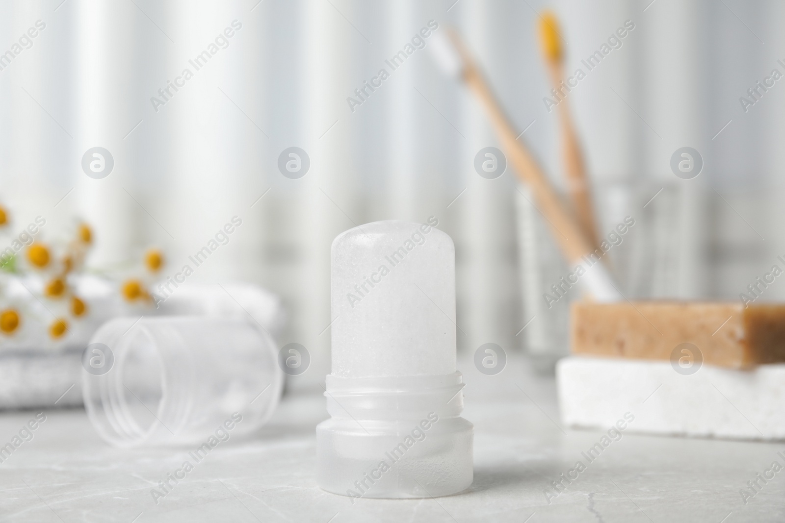 Photo of Natural crystal alum deodorant on light grey marble background