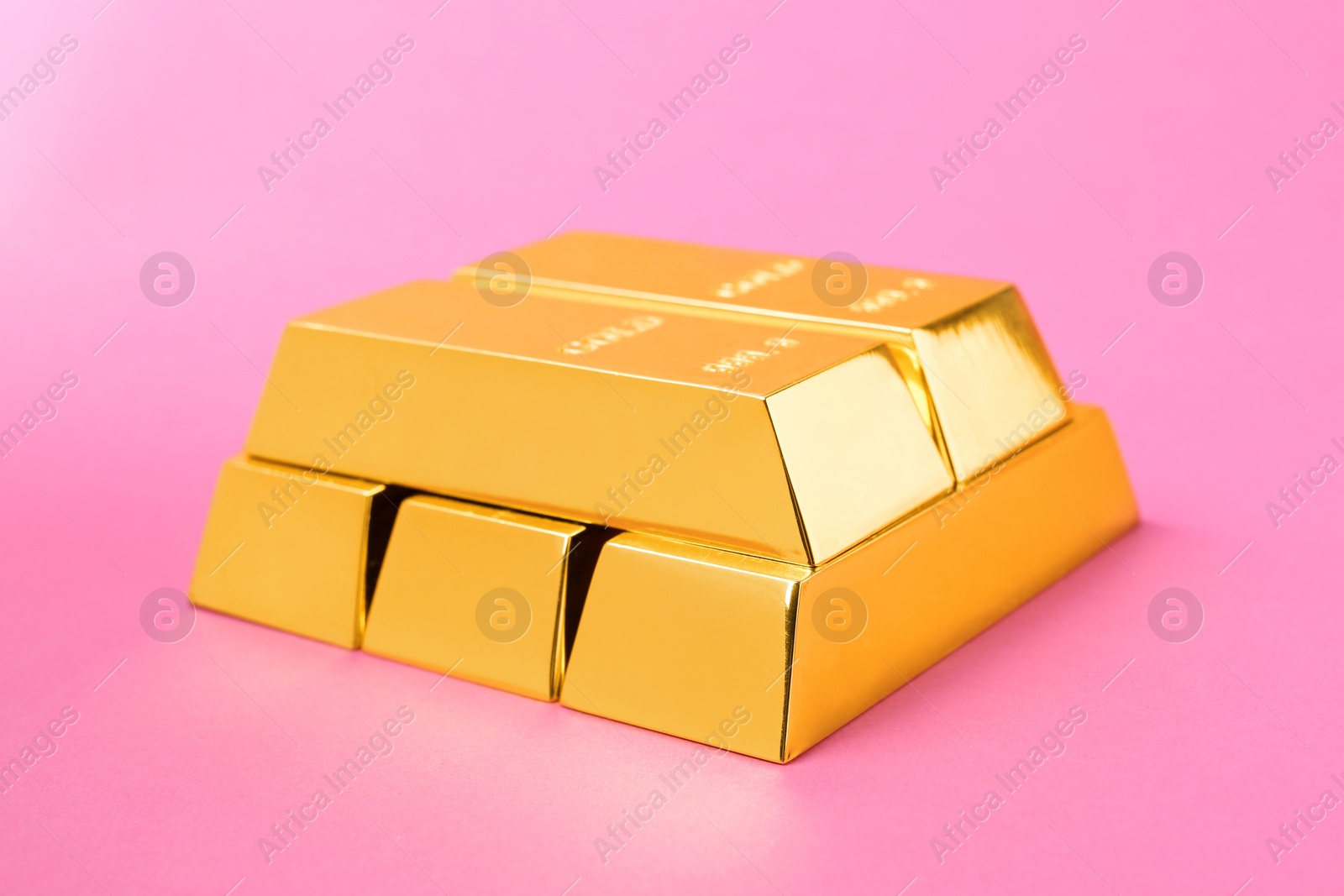 Photo of Precious shiny gold bars on color background