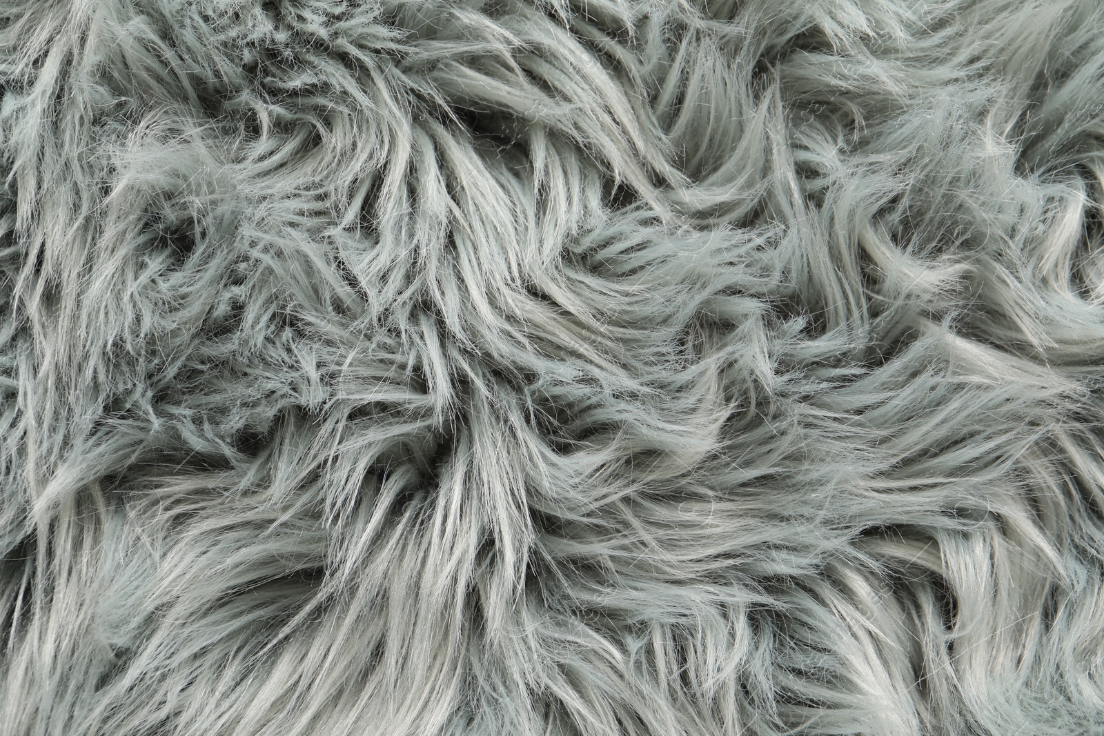 Photo of Texture of grey faux fur as background, top view