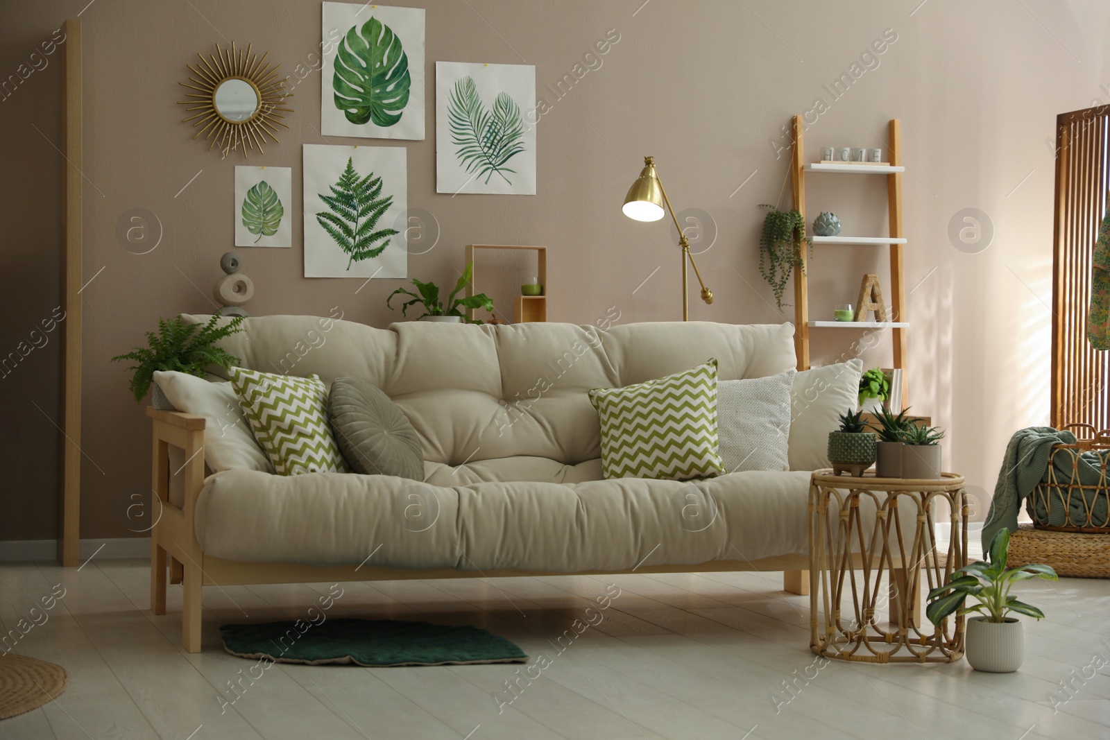 Photo of Stylish living room interior with comfortable sofa and beautiful pictures on wall