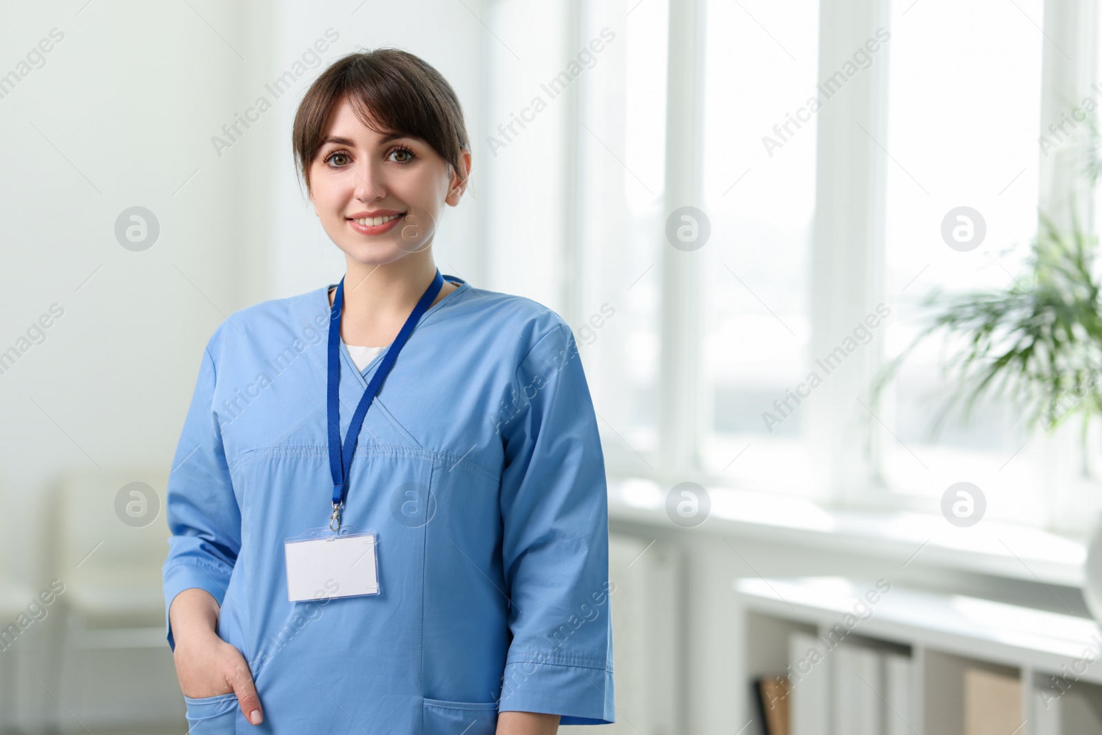 Photo of Portrait of smiling medical assistant in hospital. Space for text