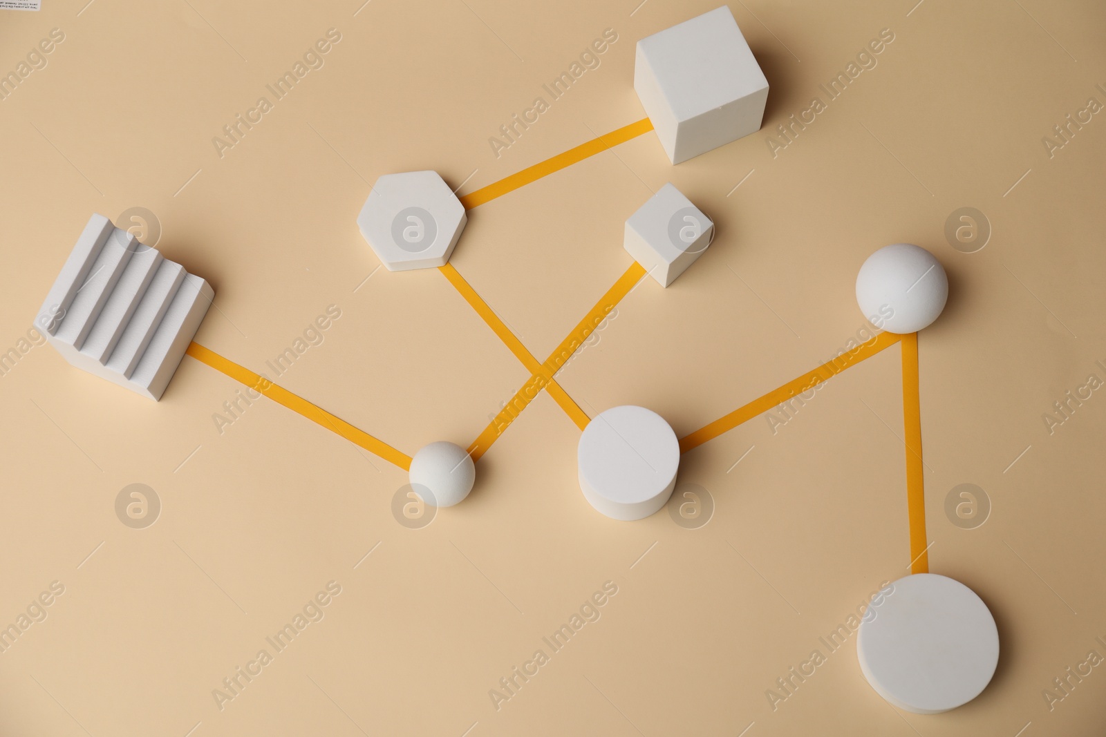 Photo of Business process organization and optimization. Scheme with geometric figures on beige background, above view