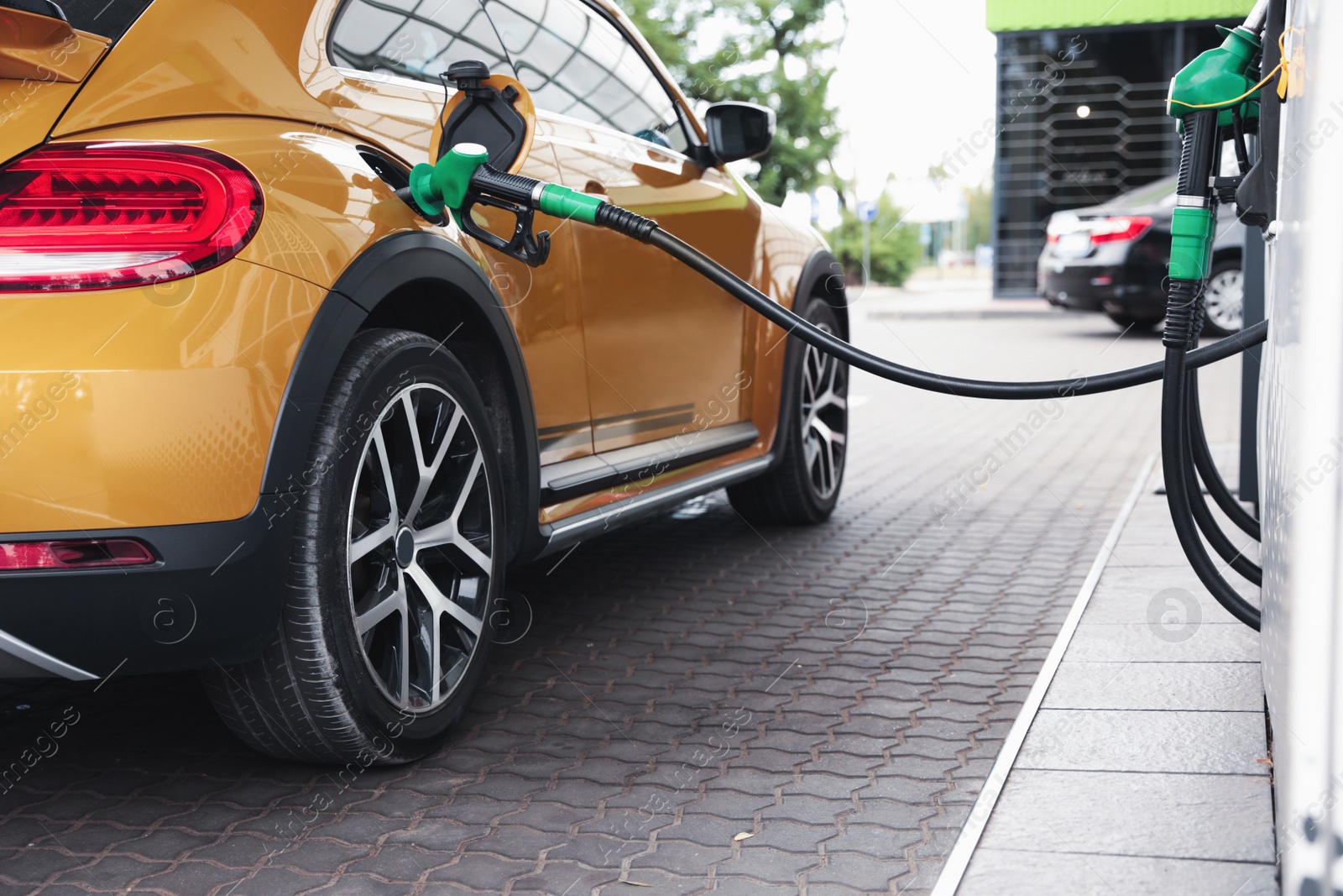 Photo of Refueling modern car at gas filling station, closeup