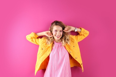 Beautiful young woman posing on color background. Summer fashion