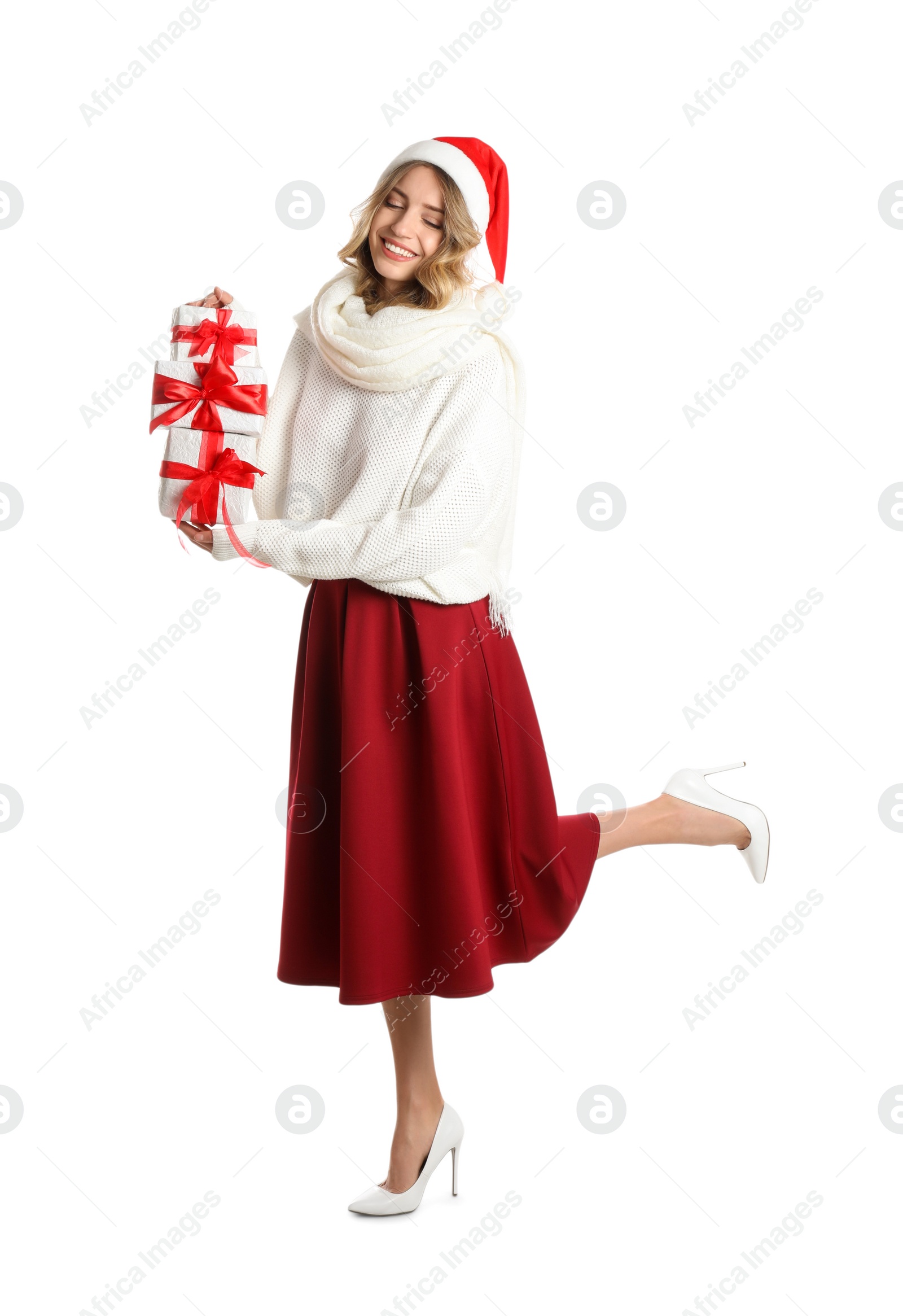 Photo of Beautiful young woman in Santa hat with Christmas presents on white background