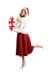 Photo of Beautiful young woman in Santa hat with Christmas presents on white background