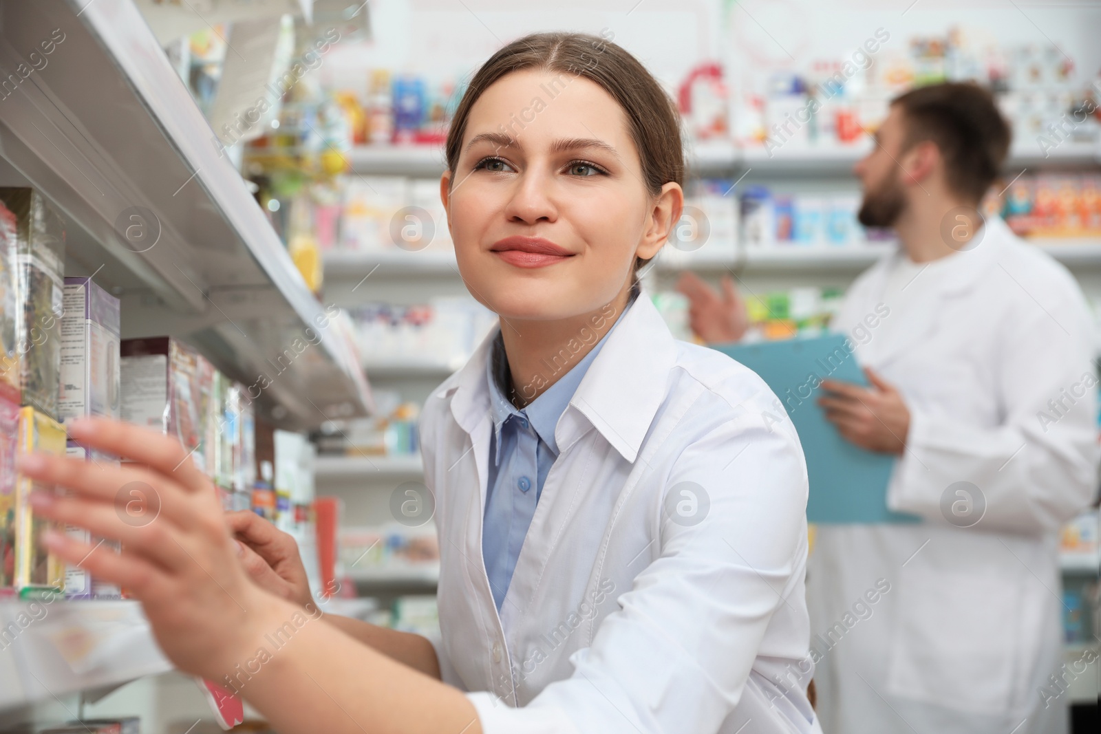 Photo of Professional pharmacist near shelves in modern drugstore