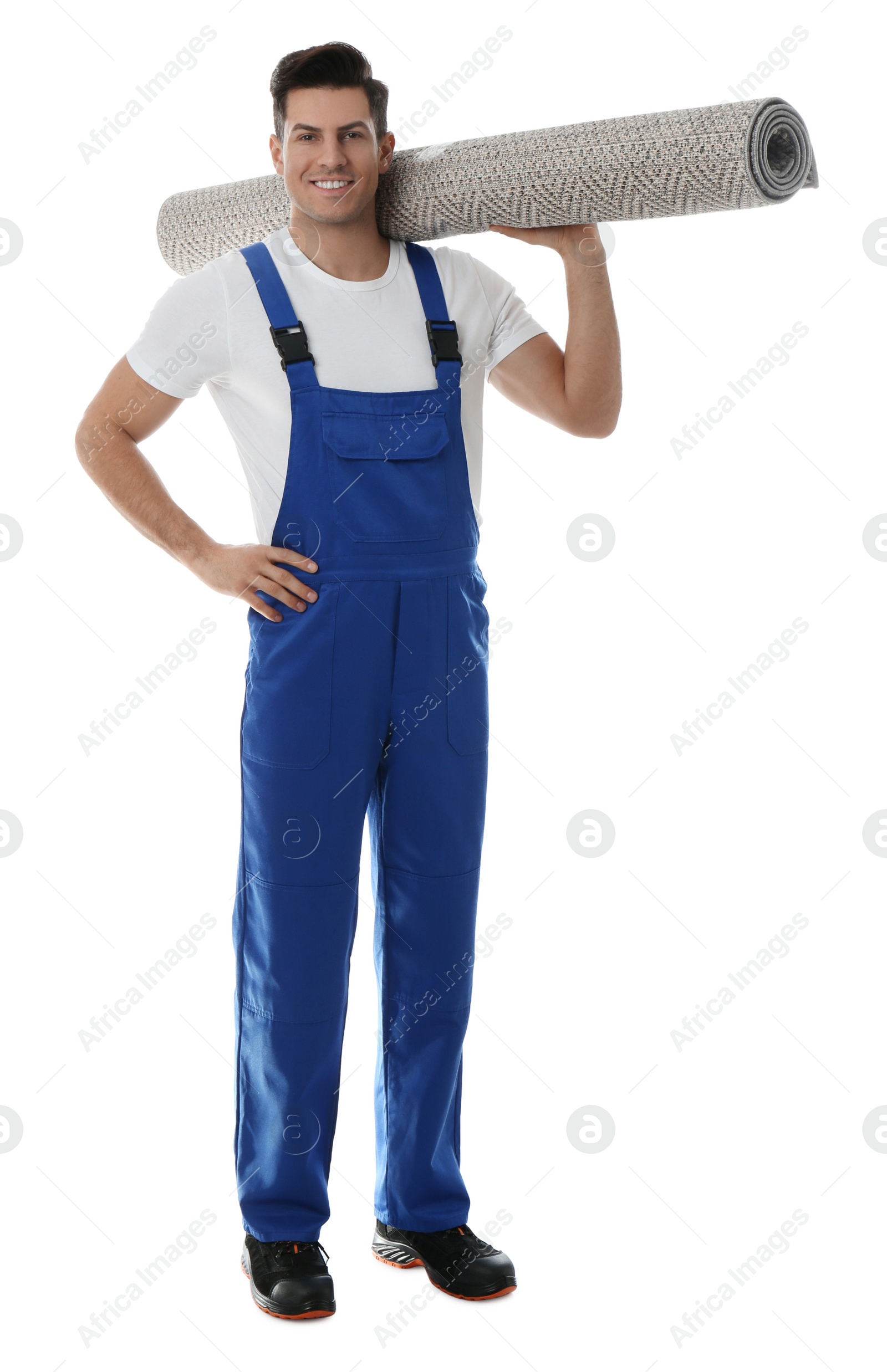 Photo of Male worker with rolled carpet on white background