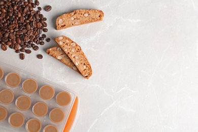 Photo of Flat lay composition with ice cube tray, coffee beans and space for text on light background