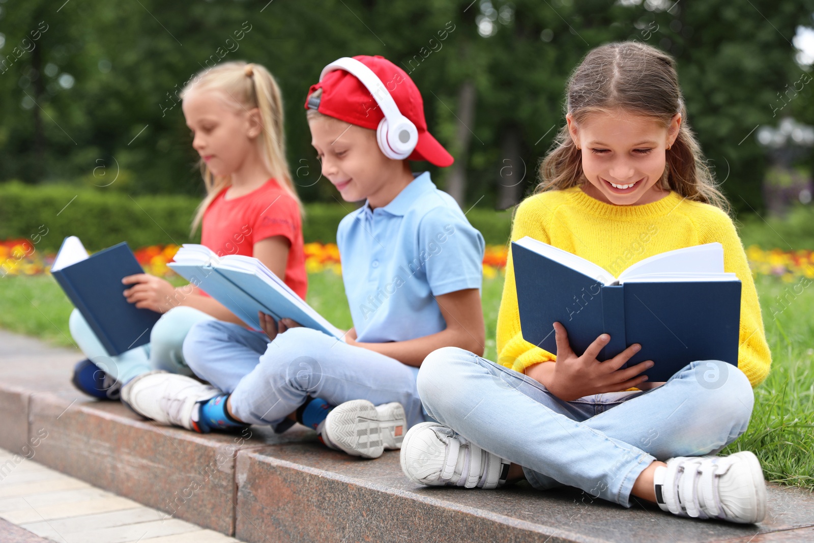 Image of Group of kids reading books on street