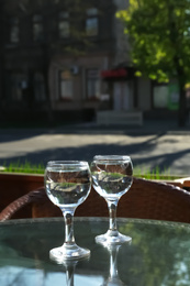 Two glasses of water at table in cafe, after coffee refreshing drink