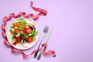 Photo of Platefresh vegetable salad and measuring tape on violet background, flat lay with space for text. Healthy diet concept