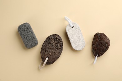 Photo of Pumice stones on beige background, flat lay