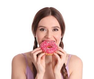 Beautiful young woman eating donut on white background