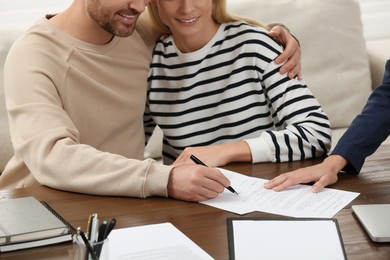 Photo of Notary working with couple in office, closeup