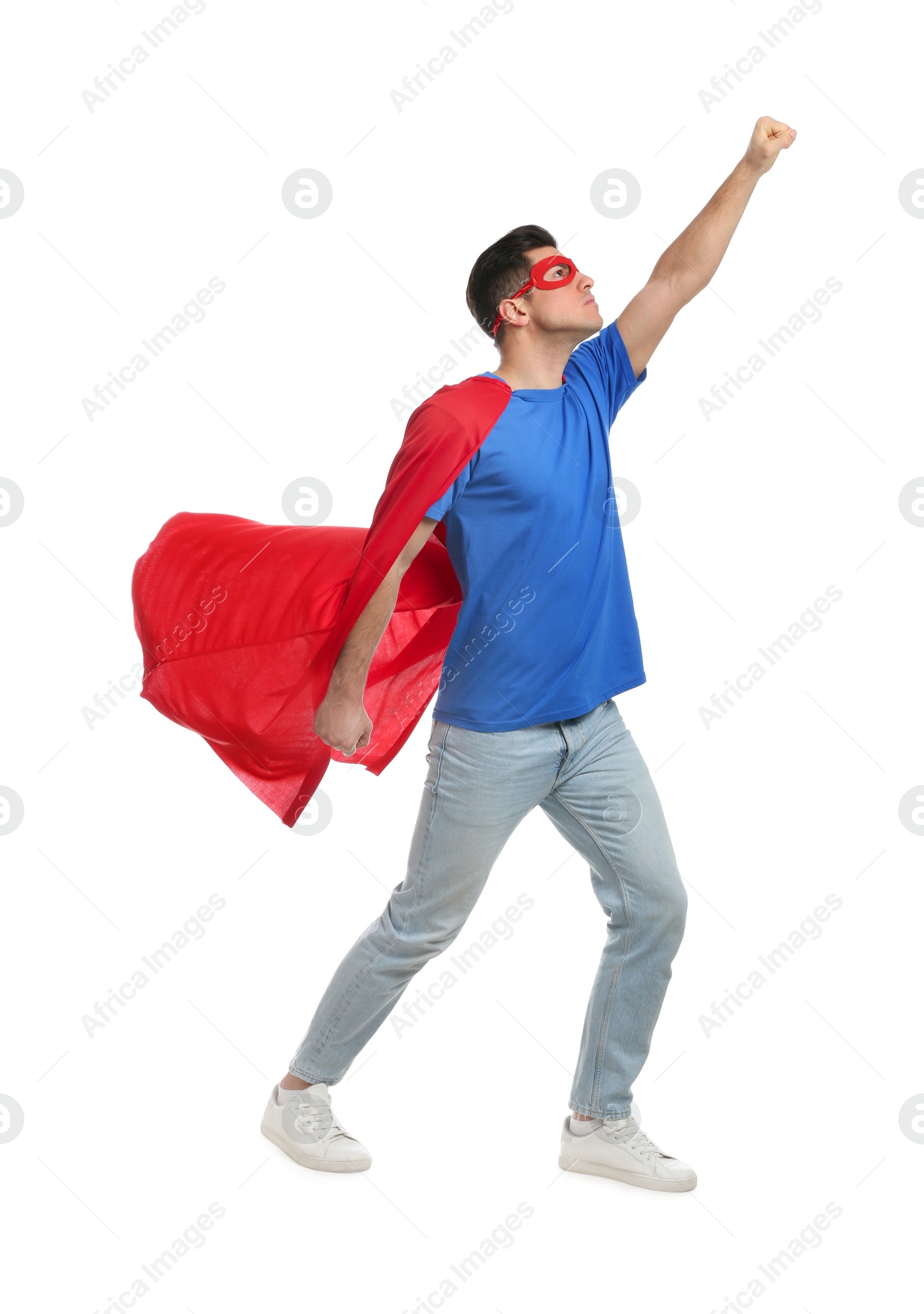 Photo of Man wearing superhero cape and mask on white background