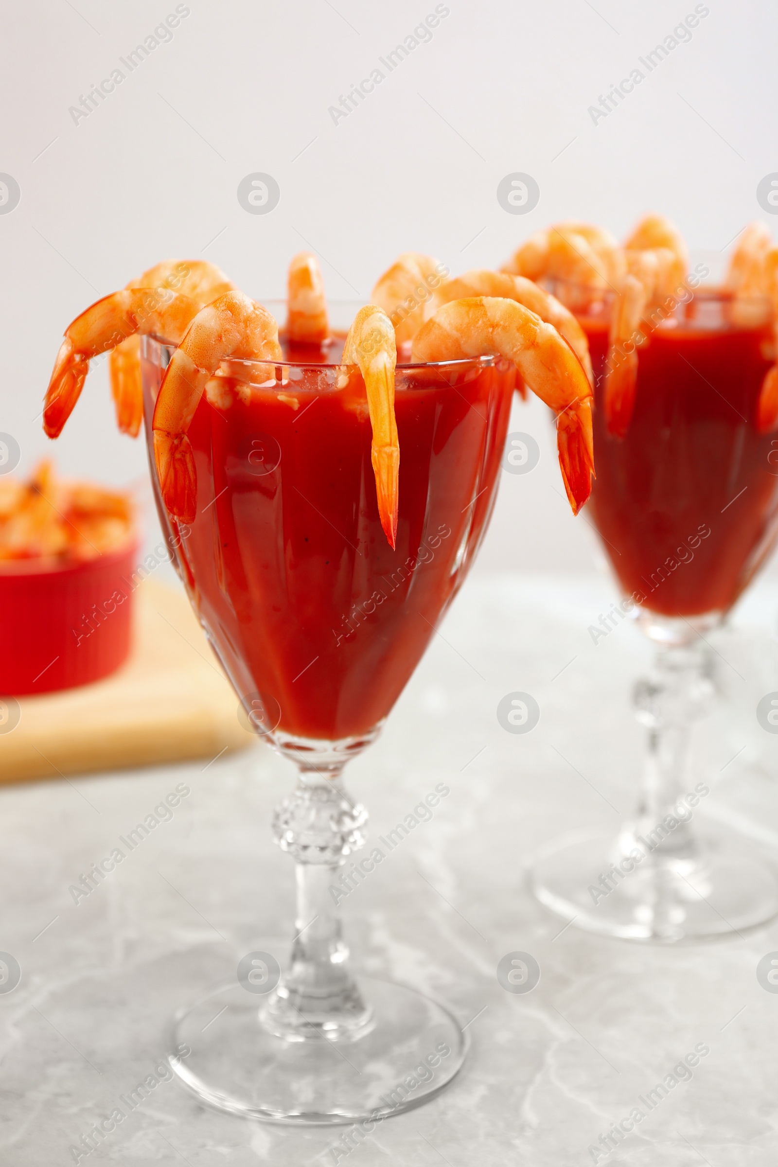 Photo of Delicious shrimp cocktail with tomato sauce served on  table