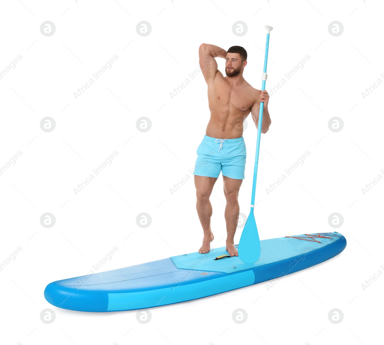 Photo of Handsome man with paddle on blue SUP board against white background