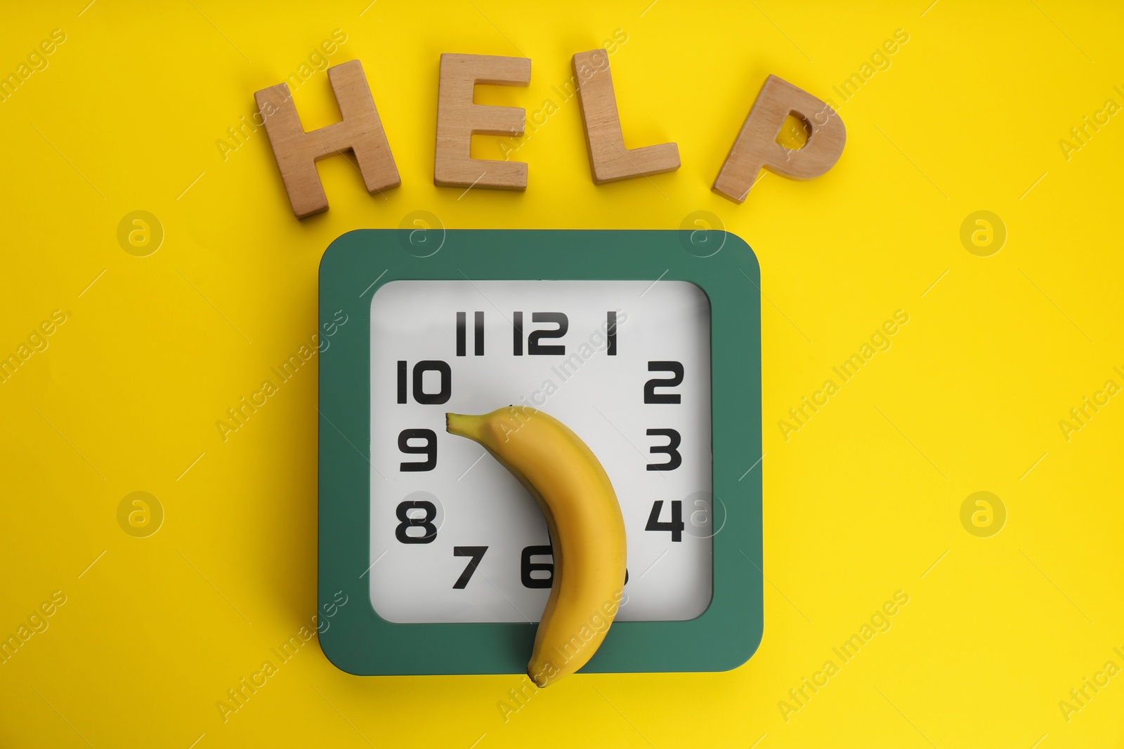 Photo of Clock with banana and word HELP on yellow background, flat lay. Potency problem concept