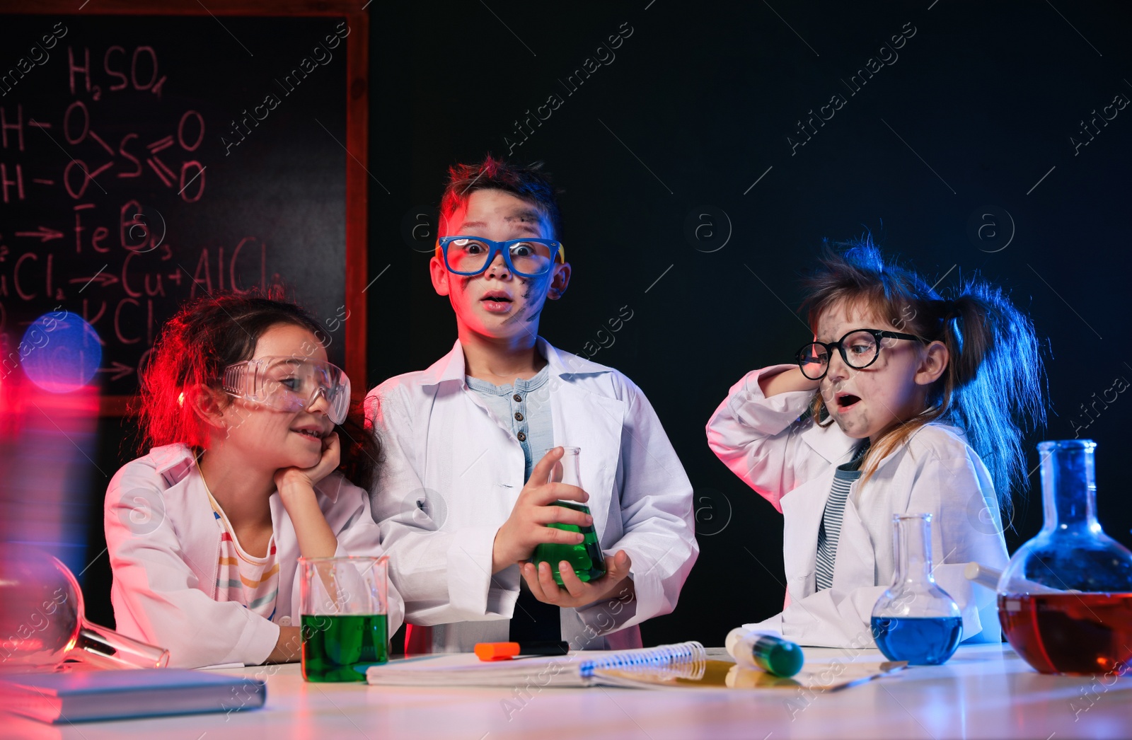 Photo of Children doing chemical research in laboratory. Dangerous experiment