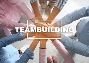 Image of People holding hands together, top view. Teambuilding concept