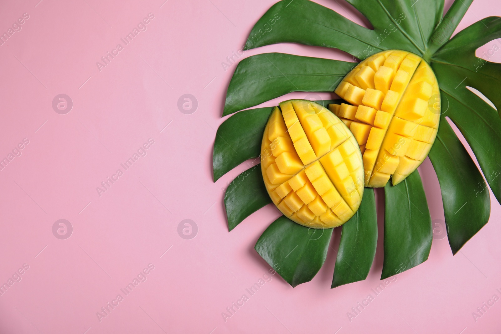 Photo of Flat lay composition with cut mango, monstera leaf and space for text on color background