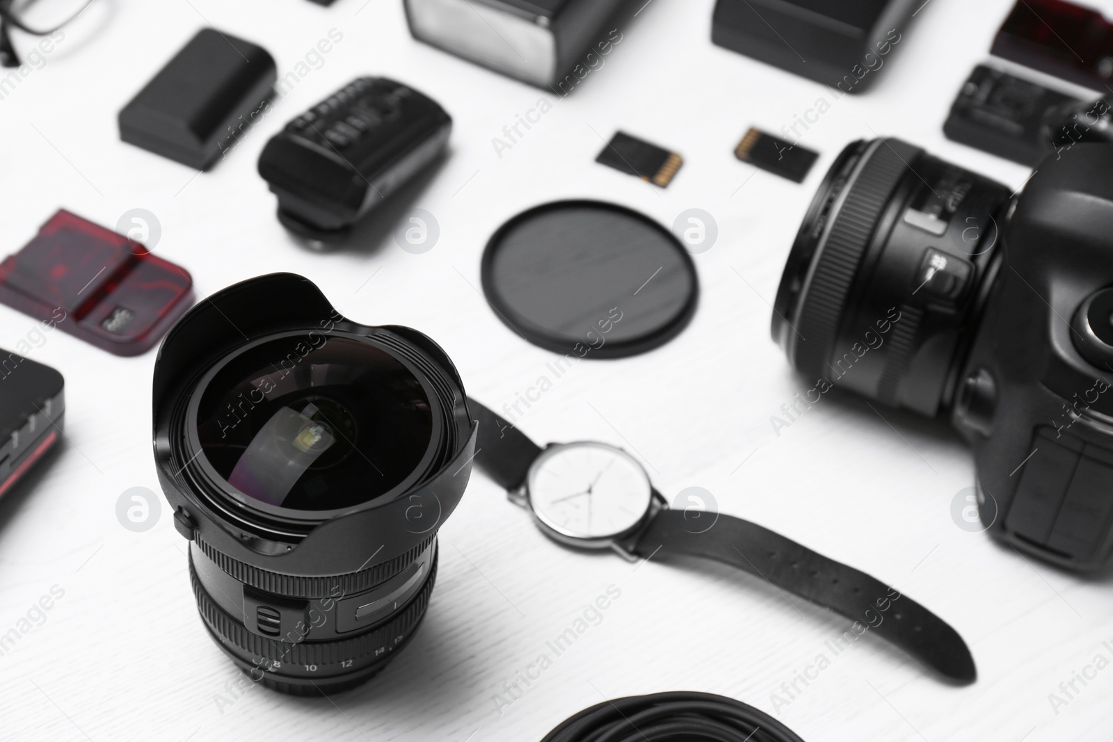 Photo of Composition with equipment for professional photographer on wooden background