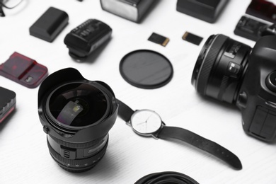 Composition with equipment for professional photographer on wooden background