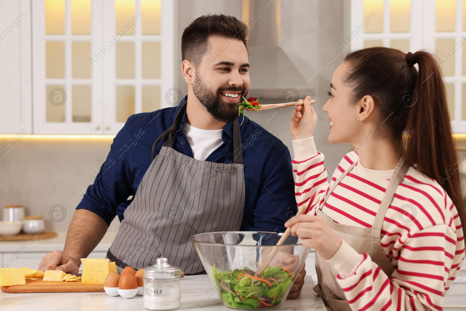 Photo of Happy lovely couple cooking together in kitchen