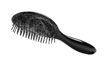 Photo of Brush with lost hair in air on white background