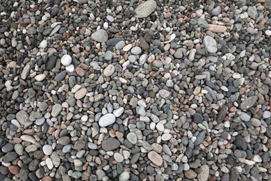 Many different pebbles as background, top view